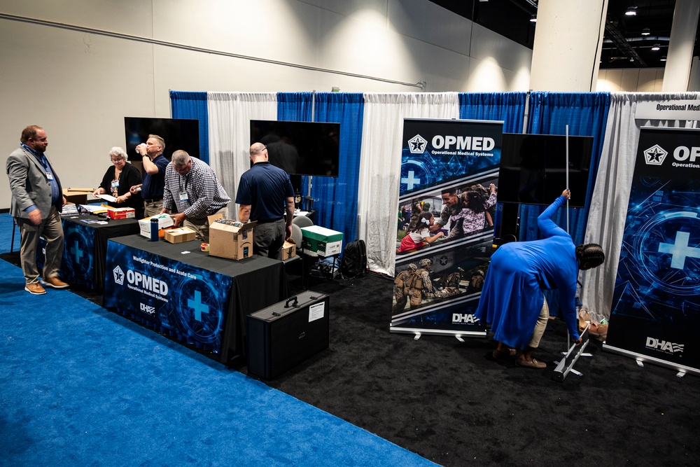 Operational Medical Systems team wraps exhibit during medical symposium day three