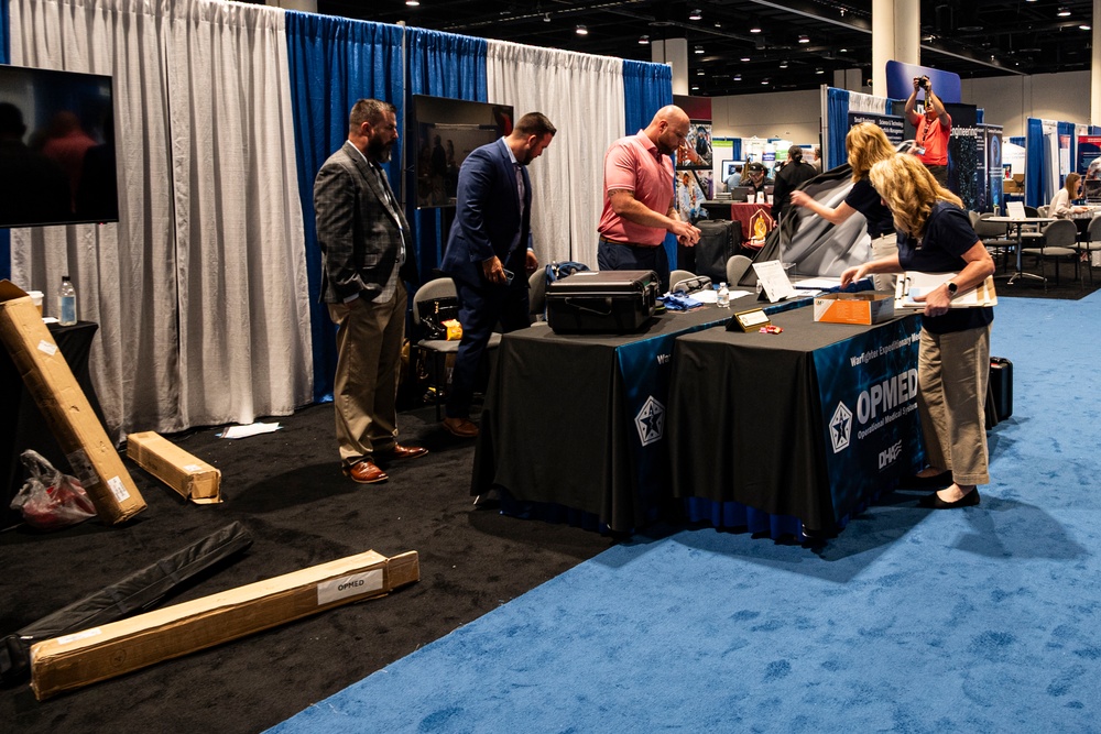 Operational Medical Systems team wraps exhibit during medical symposium day three