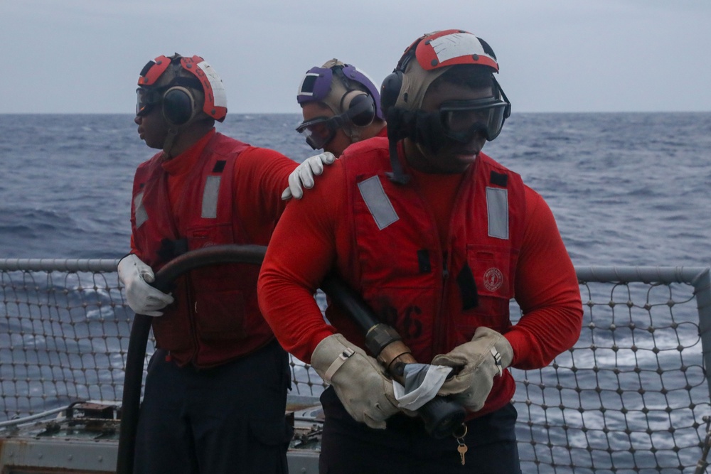 Sailors aboard the USS John Finn conduct a crash and salvage drill in the Indian Ocean