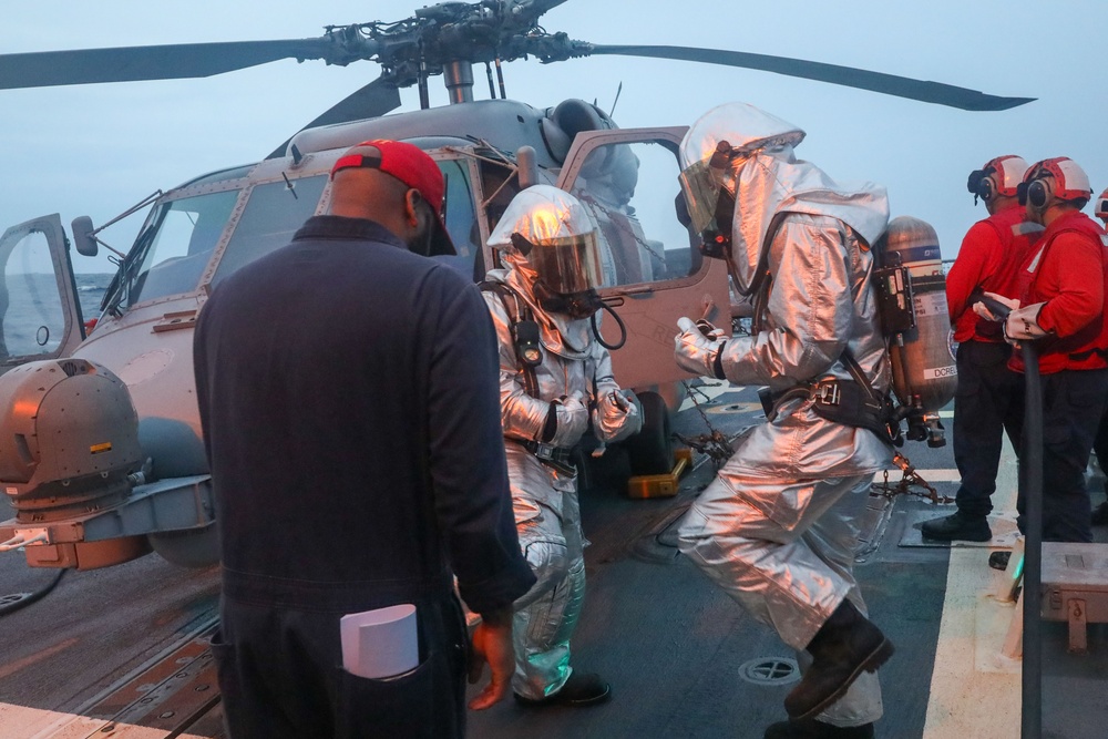 Sailors aboard the USS John Finn conduct a crash and salvage drill in the Indian Ocean