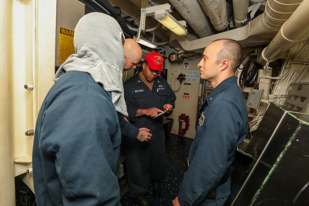 Sailors aboard the USS John Finn conduct a general quarters drill in the Andaman Sea