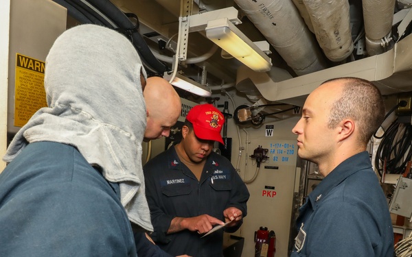 Sailors aboard the USS John Finn conduct a general quarters drill in the Andaman Sea