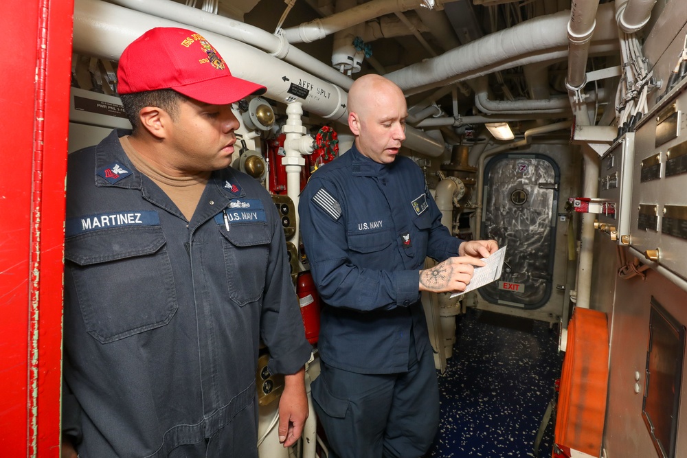 Sailors aboard the USS John Finn conduct a general quarters drill in the Andaman Sea