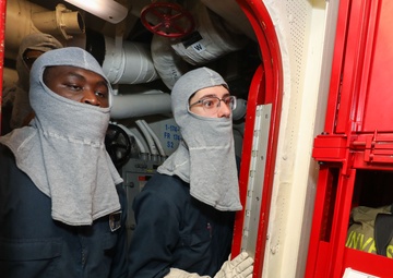 Sailors aboard the USS John Finn conduct a general quarters drill in the Andaman Sea