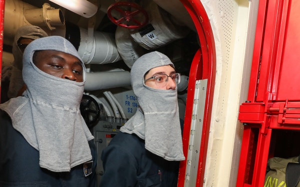 Sailors aboard the USS John Finn conduct a general quarters drill in the Andaman Sea