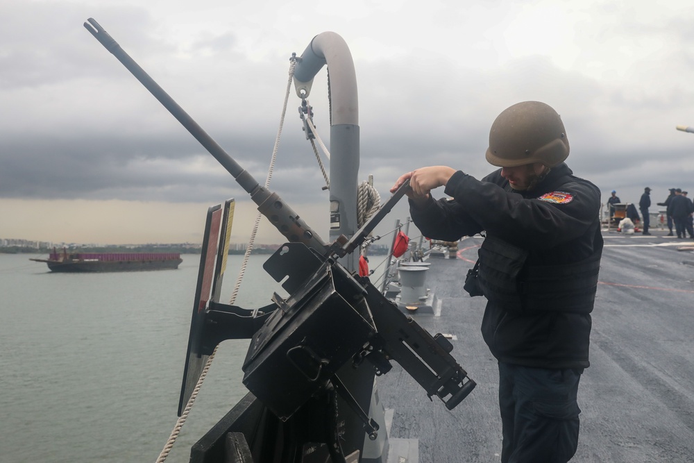 Sailors aboard the USS John Finn conduct a sea and anchor detail in Sembawang, Singapore