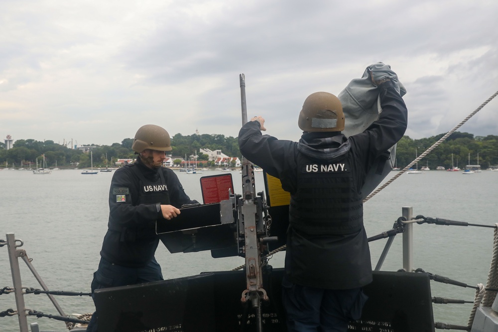 Sailors aboard the USS John Finn conduct a sea and anchor detail in Sembawang, Singapore