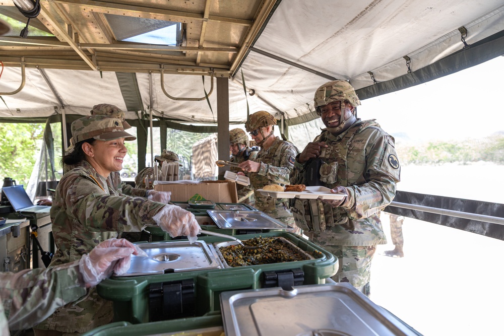 Chief Warrant Officer 5 LaShon P. White receives food