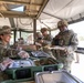 Chief Warrant Officer 5 LaShon P. White receives food