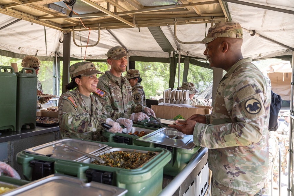 Command Sgt. Maj. Gregory Betty receives food