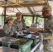 Command Sgt. Maj. Gregory Betty receives food