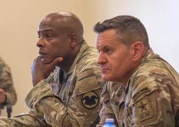 Sgt. Maj. of the Army Michael R. Weimer and Command Sgt. Maj. Gregory Betty listen to a brief