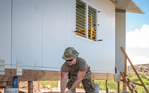 Airman digs trenches for water lines