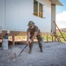 Airman digs trenches for water lines