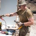 Airmen drill holes in a building for electrical wiring in Hawaii