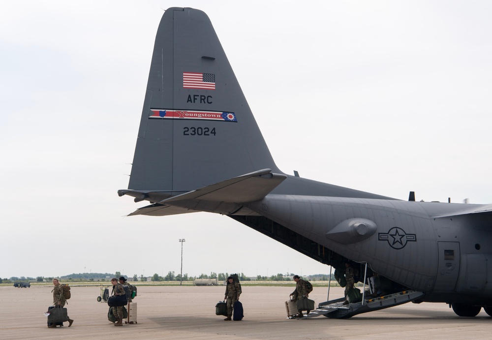 U.S. Reserve Airmen exit a C-130 Super Hercules upon arrival for Patriot Medic 25