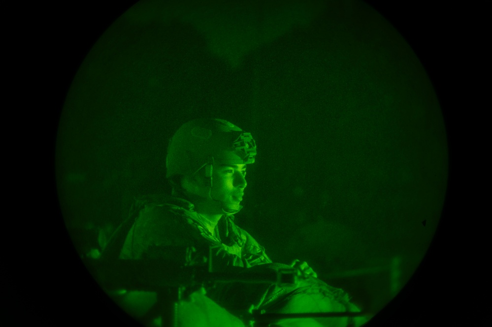 Airmen stand watch at night during Exercise Northern Strike 25-2