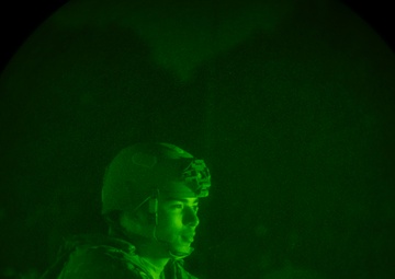 Airmen stand watch at night during Exercise Northern Strike 25-2