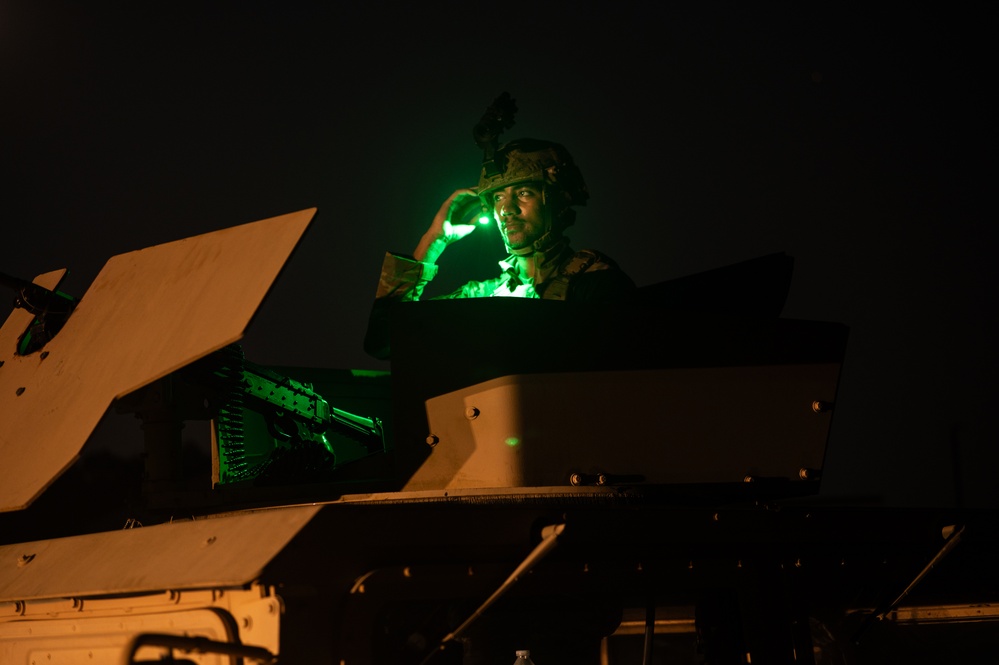 Airmen stand watch at night during Exercise Northern Strike 25-2