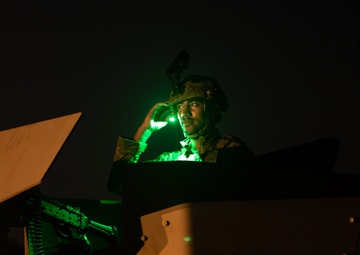 Airmen stand watch at night during Exercise Northern Strike 25-2