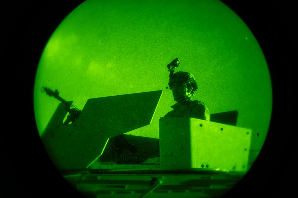 Airmen stand watch at night during Exercise Northern Strike 25-2