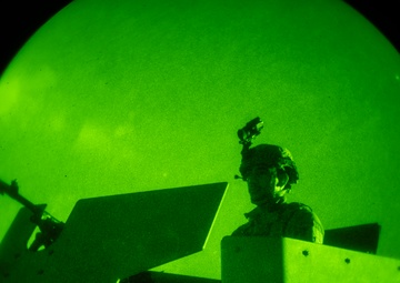 Airmen stand watch at night during Exercise Northern Strike 25-2