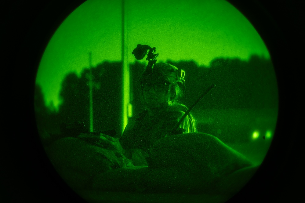Airmen stand watch at night during Exercise Northern Strike 25-2