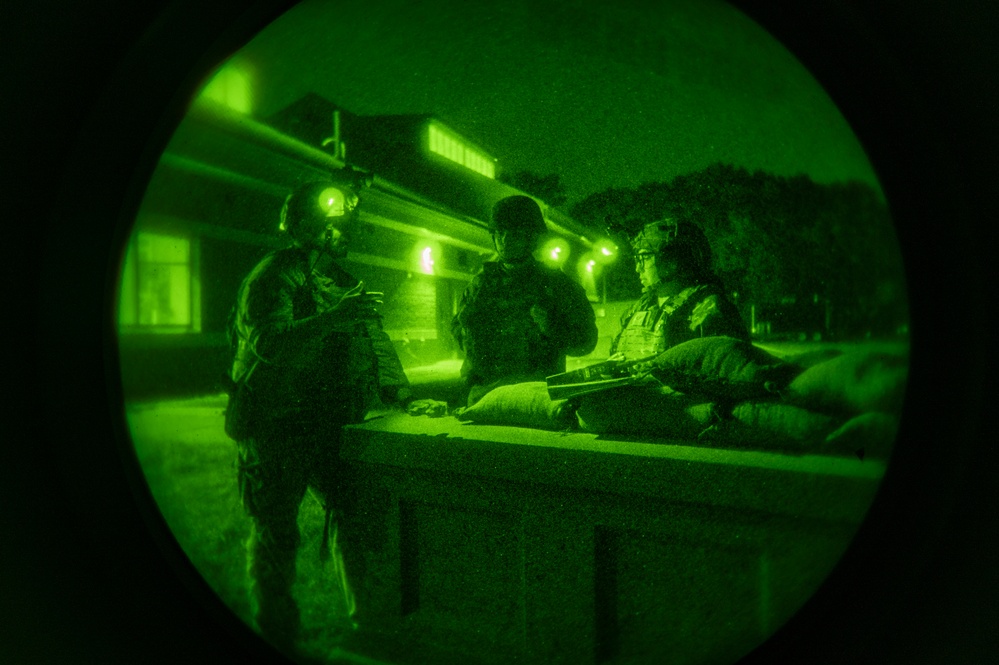 Airmen stand watch at night during Exercise Northern Strike 25-2