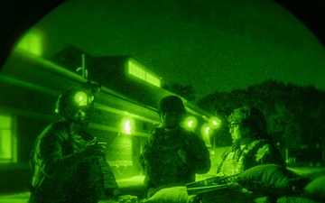 Airmen stand watch at night during Exercise Northern Strike 25-2