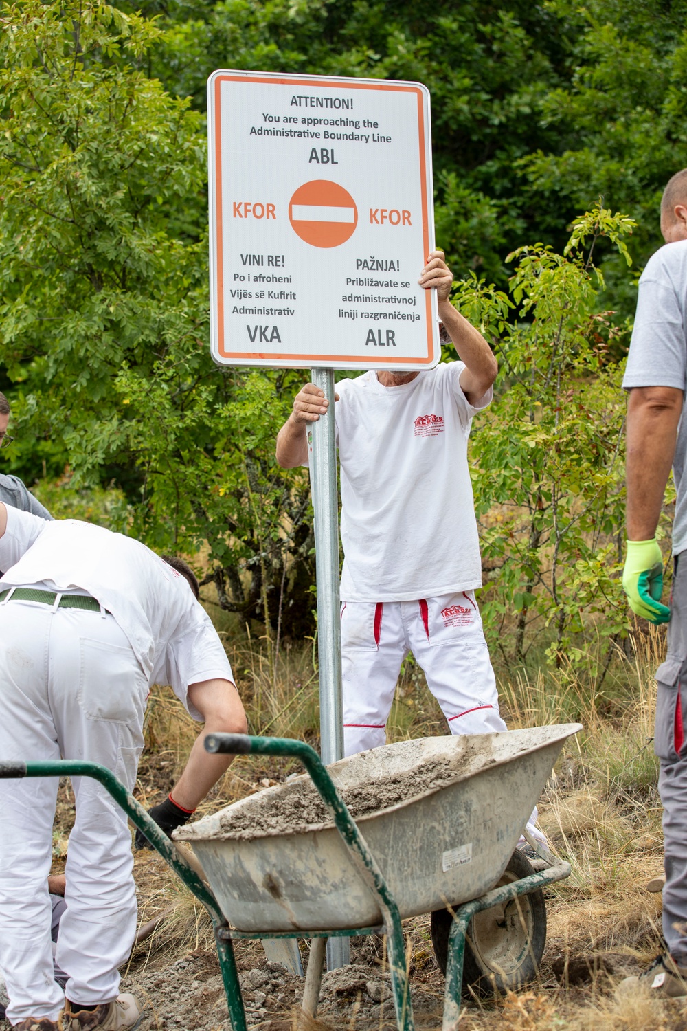 NATO-led KFOR mission along with local contractors install signs along the ABL
