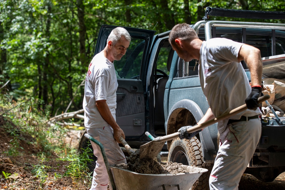 NATO-led KFOR mission along with local contractors install signs along the ABL