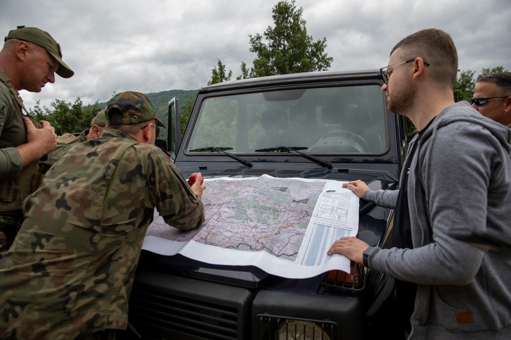 NATO-led KFOR mission along with local contractors install signs along the ABL