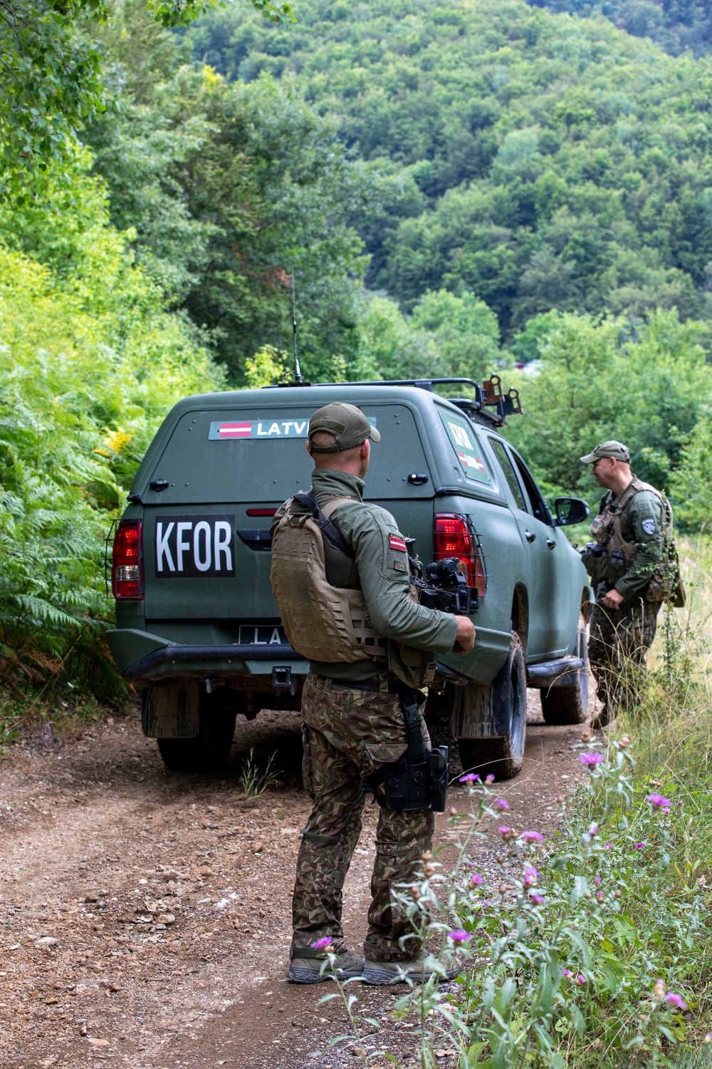 NATO-led KFOR mission along with local contractors install signs along the ABL