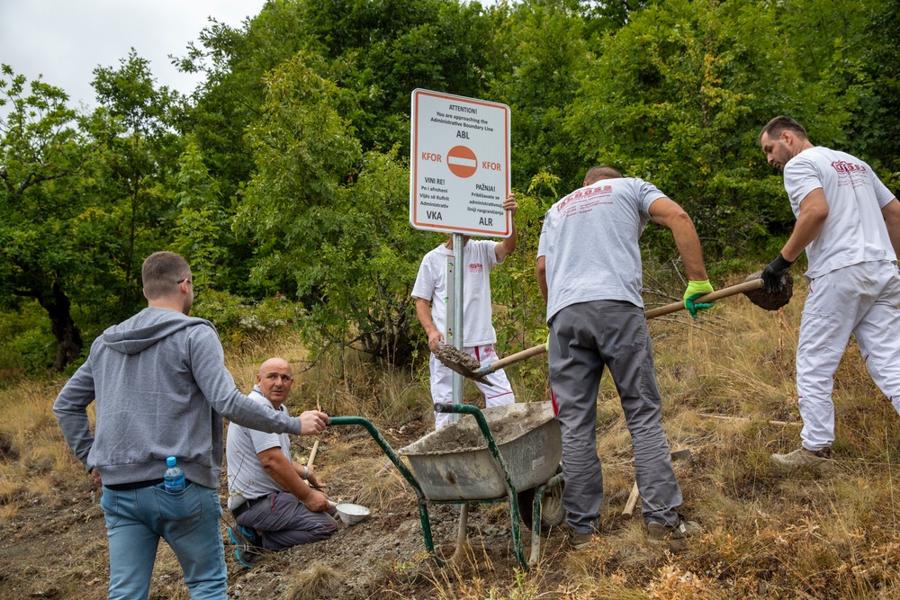 NATO-led KFOR mission along with local contractors install signs along the ABL