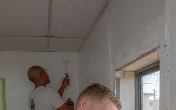U.S. Marines with HQ Bn., 1st MARDIV paint George’s Place