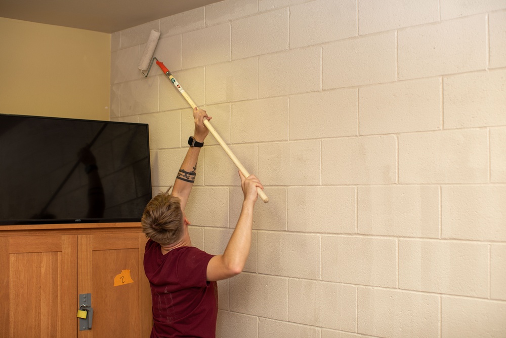 U.S. Marines with HQ Bn., 1st MARDIV paint barracks room