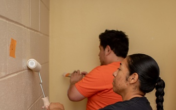 U.S. Marines with HQ Bn., 1 MARDIV paint barracks room