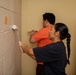 U.S. Marines with HQ Bn., 1 MARDIV paint barracks room