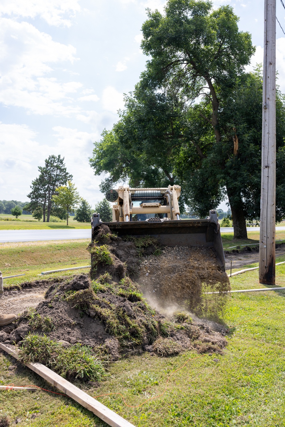 Skid-Steer Clears the Way for Sidewalk