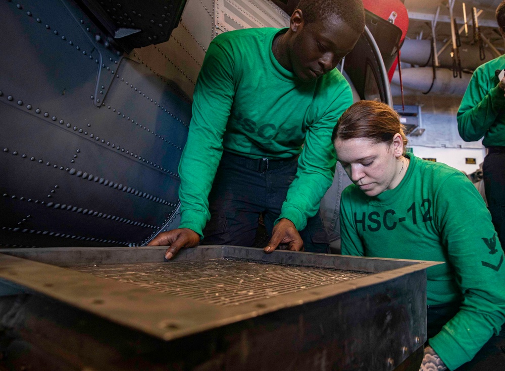 Sailors Conduct Aircraft Maintenance in the Hangar Bay Aboard George Washington