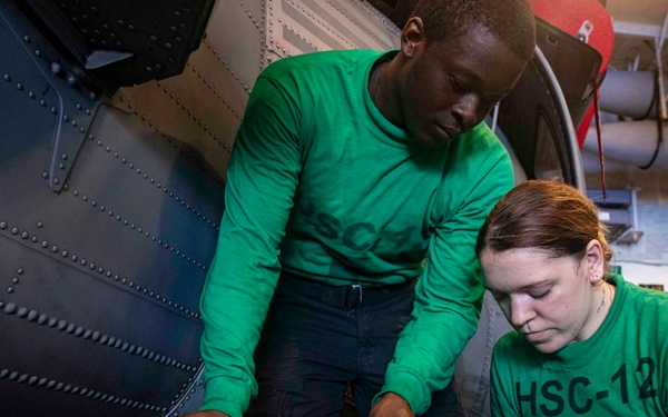 Sailors Conduct Aircraft Maintenance in the Hangar Bay Aboard George Washington