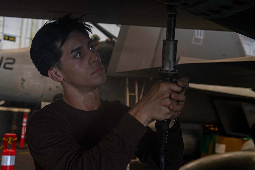 Sailors Conduct Aircraft Maintenance in the Hangar Bay Aboard George Washington
