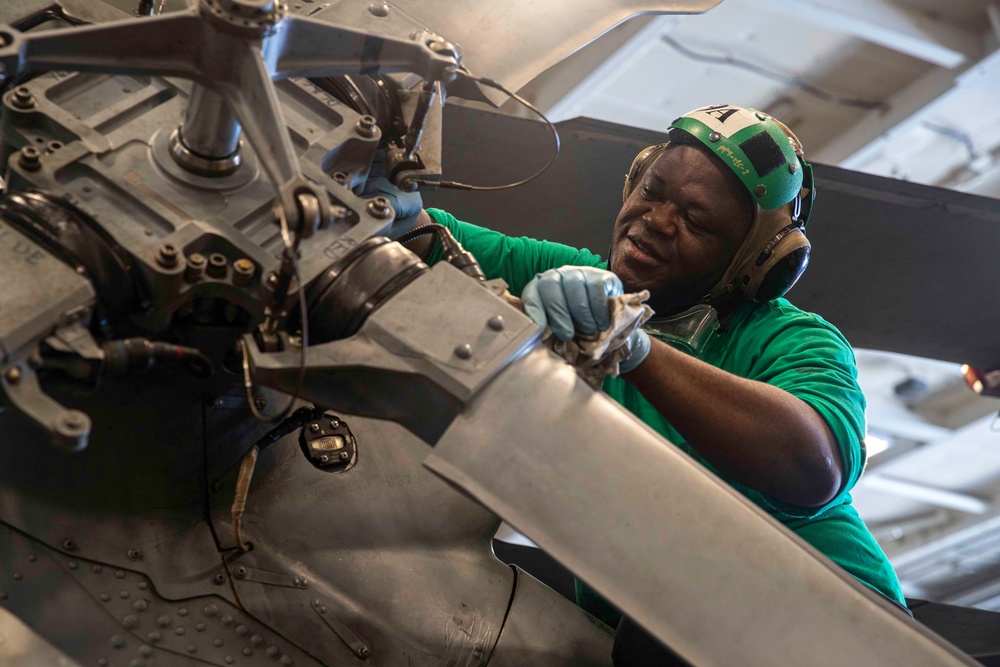 Sailors Conduct Aircraft Maintenance in the Hangar Bay Aboard George Washington
