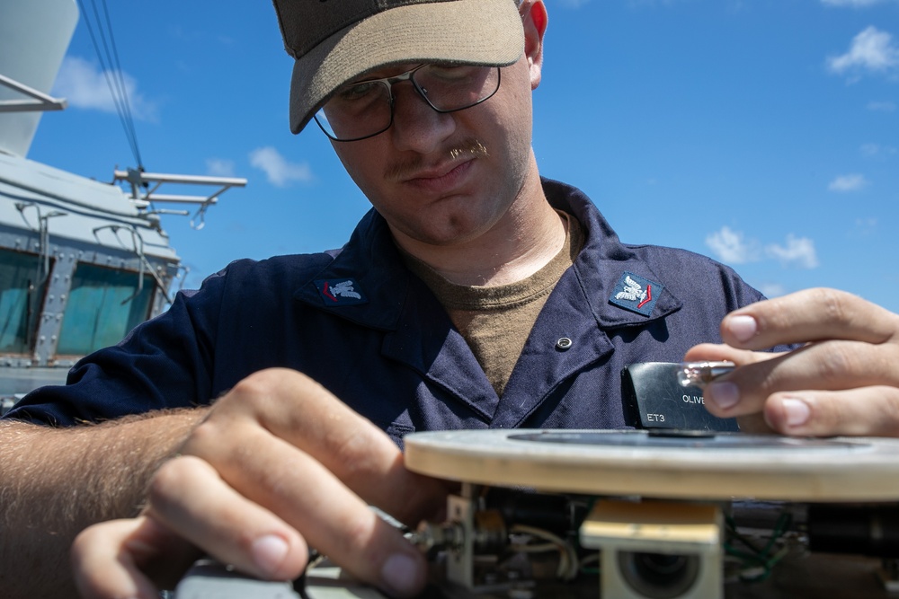 USS Mitscher (DDG 57) Sailor conducts bridge maintenance