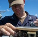 USS Mitscher (DDG 57) Sailor conducts bridge maintenance