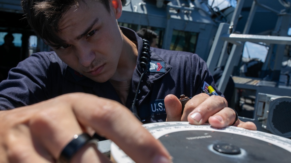 USS Mitscher (DDG 57) Sailor conducts bridge maintenance