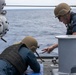 USS Mitscher (DDG 57) Sailors conduct small arms live fire exercise