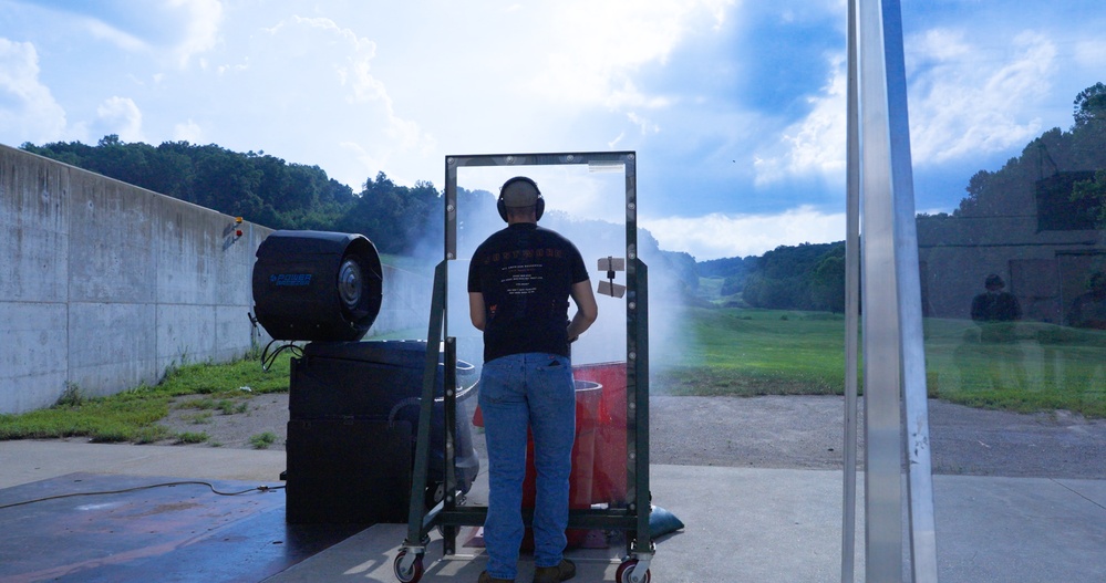 A test engineer manually fires the GAU-21 machine gun