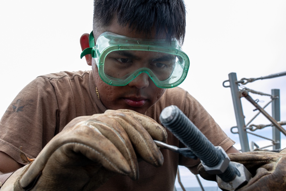 USS Mitscher (DDG 57) Sailor conducts maintenance