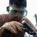 USS Mitscher (DDG 57) Sailor conducts maintenance